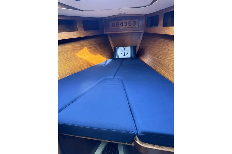 Slide: The Image of Interior cabin of 1984 Barberis 38 sailboat with blue cushions and wooden finish. - 25