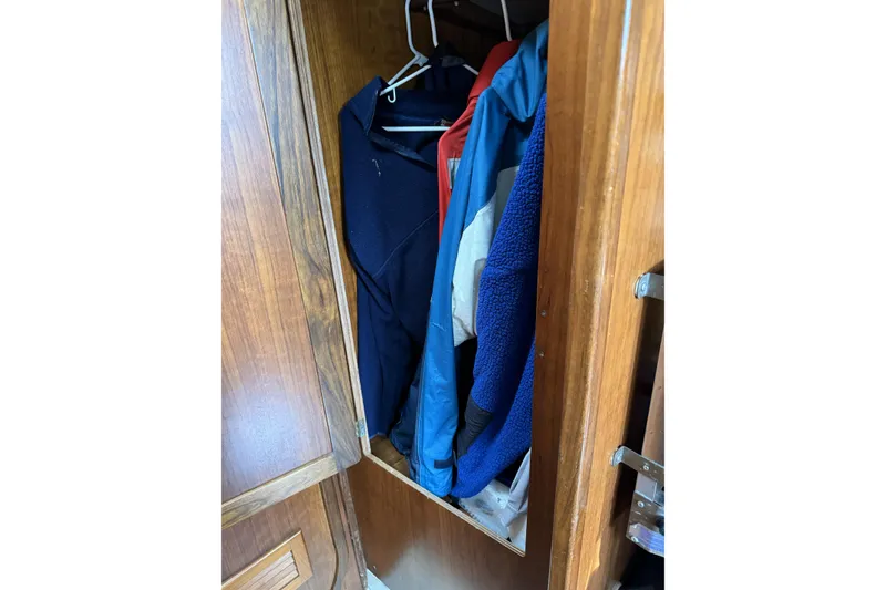 Slide: The Image of Wooden closet with hanging jackets inside a Barberis 38, 1984 model. - 27