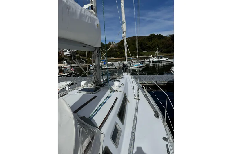 Slide: The Image of 1984 Barberis 38 sailboat docked at a marina under a clear blue sky. - 3