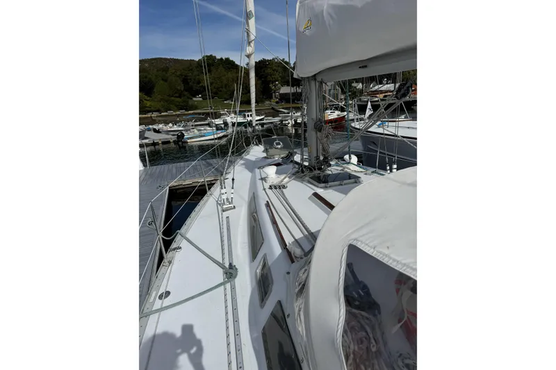 Slide: The Image of Sailboat Barberis 38, 1984 model, docked at marina with clear sky. - 4