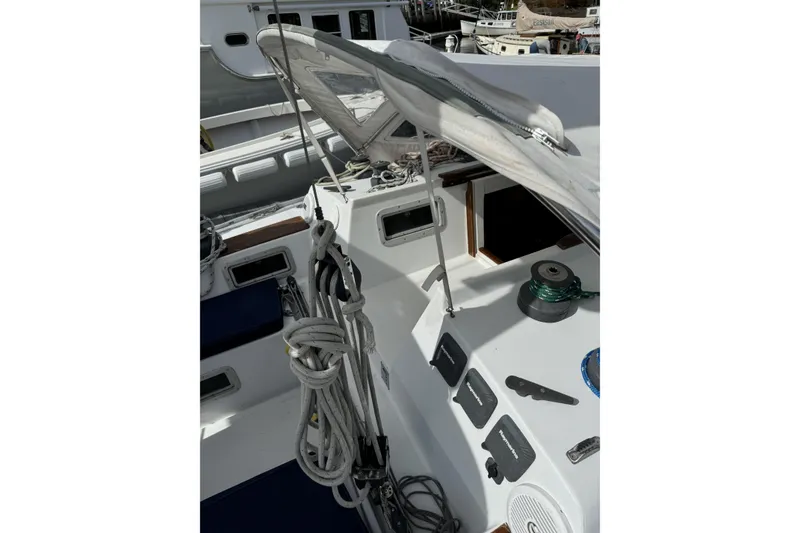 Slide: The Image of 1984 Barberis 38 sailboat cockpit with ropes and equipment, docked in a marina. - 5