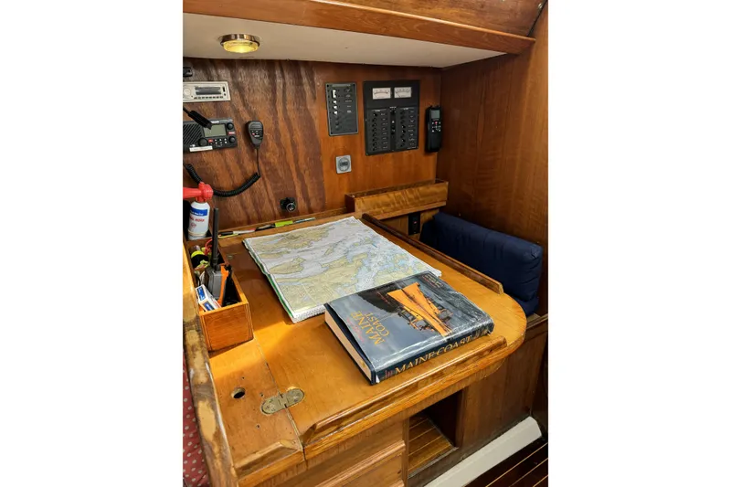 Slide: The Image of Navigation station on 1984 Barberis 38 sailboat with map and book. - 6