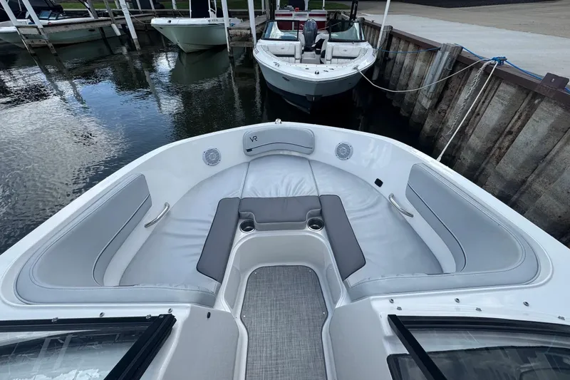Slide: The Image of 2023 Bayliner VR6 Bowrider OB interior with spacious seating at dock. - 10