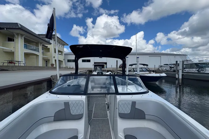 Slide: The Image of 2023 Bayliner VR6 Bowrider OB docked at marina under blue sky. - 14