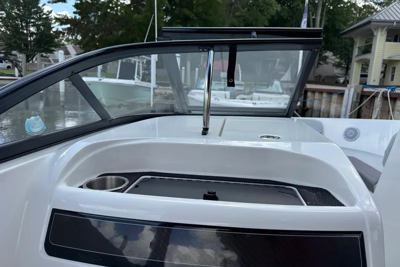 Slide: The Image of 2023 Bayliner VR6 Bowrider OB interior with windshield and storage compartment. - 15