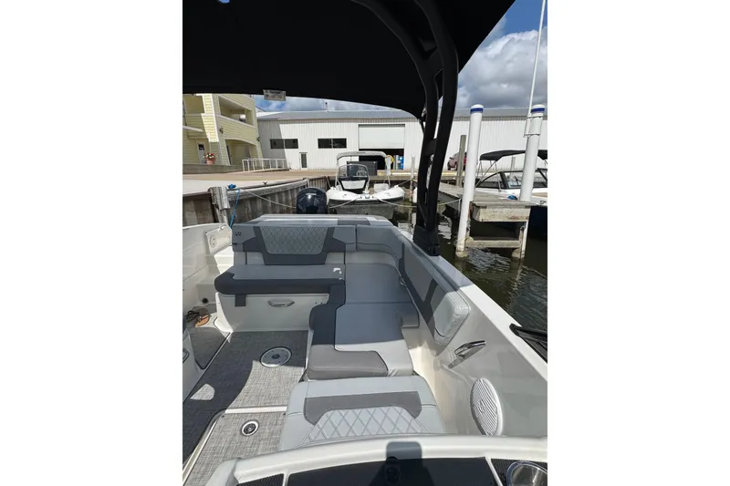 Slide: The Image of 2023 Bayliner VR6 Bowrider OB interior with gray seating, docked at marina. - 19