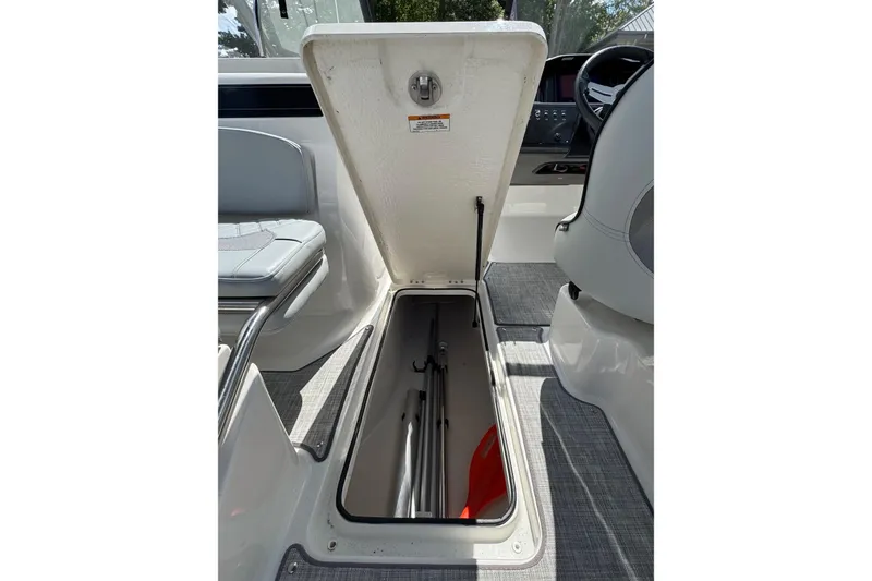 Slide: The Image of 2023 Bayliner VR6 Bowrider OB storage compartment open, showcasing interior space. - 21