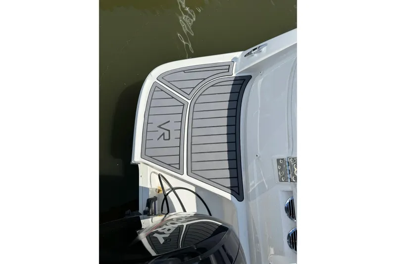 Slide: The Image of 2023 Bayliner VR6 Bowrider OB boat deck with VR logo, docked on water. - 3