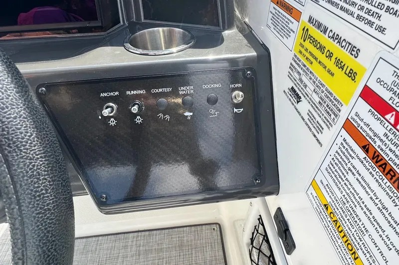 Slide: The Image of Control panel of 2023 Bayliner VR6 Bowrider OB with switches and capacity warnings. - 7
