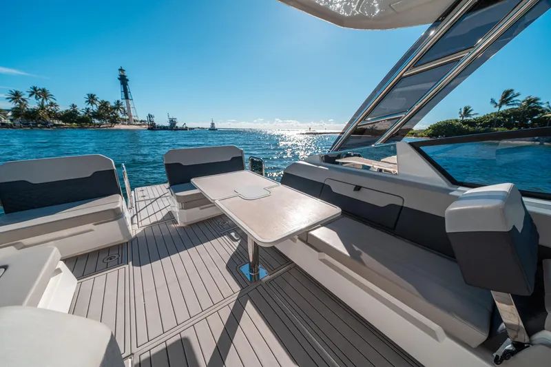 Slide: The Image of Aquila 32 Sport 2022 yacht interior with ocean view and island backdrop. - 12