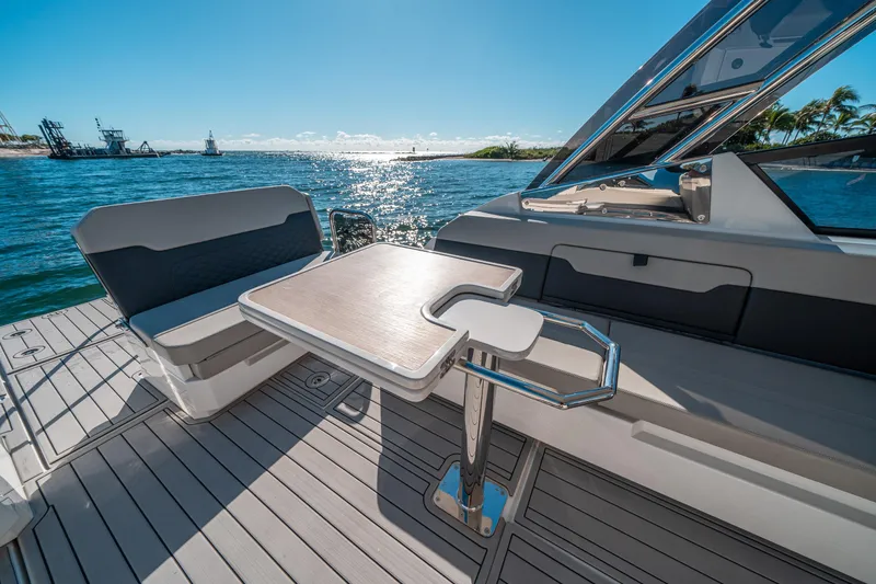 Slide: The Image of Aquila 32 Sport 2022 boat interior with seating and table, ocean view. - 14