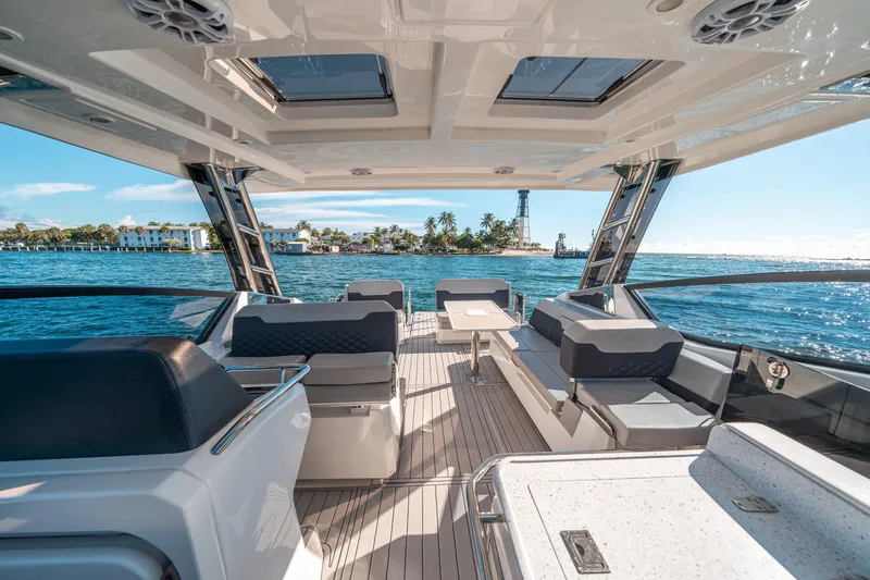 Slide: The Image of Luxurious 2022 Aquila 32 Sport yacht interior with ocean view and modern seating. - 15