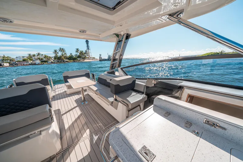 Slide: The Image of Luxurious 2022 Aquila 32 Sport yacht interior with ocean view and modern seating. - 16