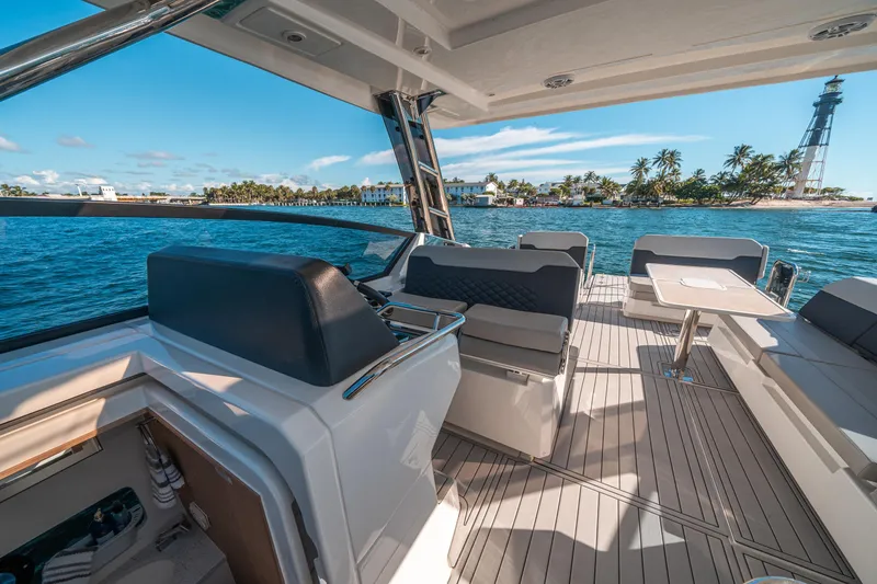 Slide: The Image of 2022 Aquila 32 Sport yacht interior with ocean view and lighthouse in background. - 17
