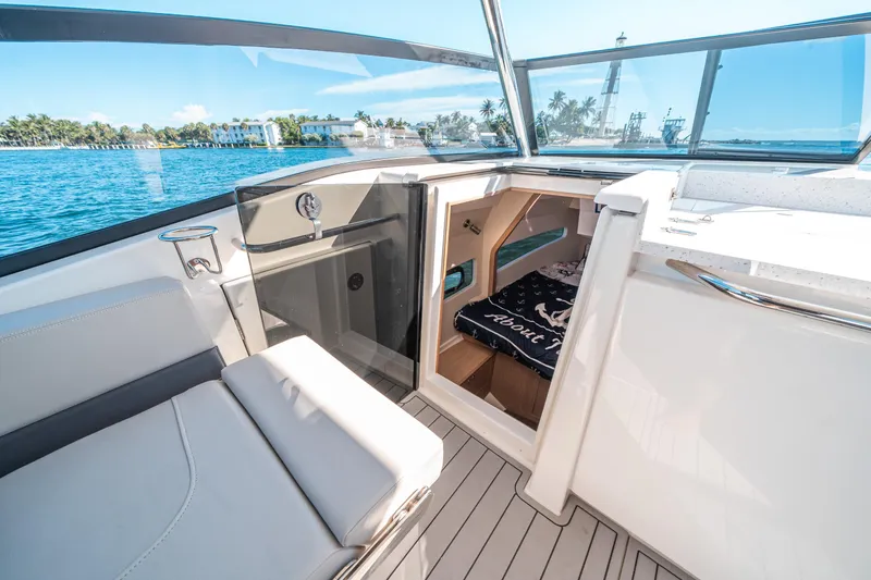 Slide: The Image of 2022 Aquila 32 Sport boat interior with open cabin and waterfront view. - 19