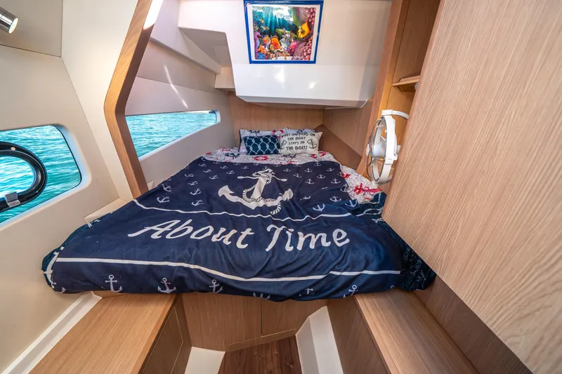 Slide: The Image of Cozy cabin interior of 2022 Aquila 32 Sport with nautical-themed bedding. - 20