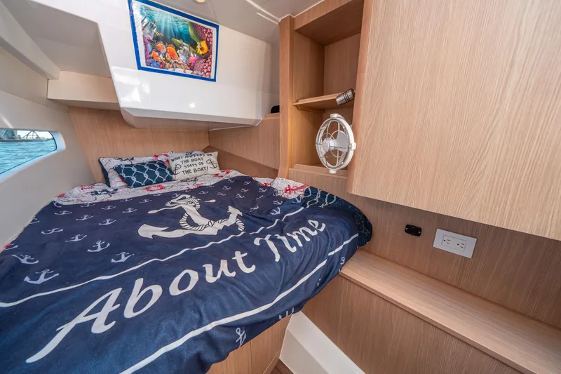 Slide: The Image of Cozy cabin interior of 2022 Aquila 32 Sport with nautical-themed bedding. - 21