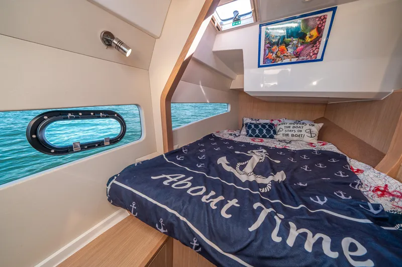 Slide: The Image of Cozy cabin interior of 2022 Aquila 32 Sport yacht with nautical-themed bedding. - 22