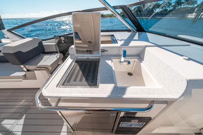 Slide: The Image of Aquila 32 Sport 2022 yacht with sleek outdoor kitchen and ocean view. - 24