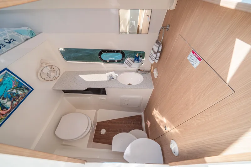 Slide: The Image of Modern bathroom interior of 2022 Aquila 32 Sport yacht, featuring sink, toilet, and window. - 28