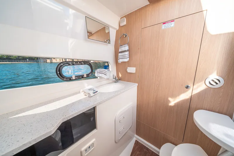 Slide: The Image of Interior of 2022 Aquila 32 Sport yacht bathroom with window view and modern amenities. - 30