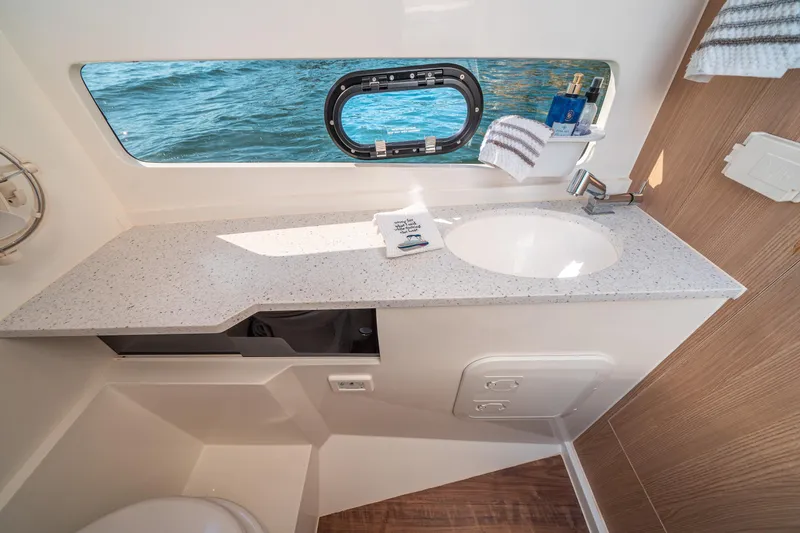 Slide: The Image of Bathroom interior of 2022 Aquila 32 Sport yacht with ocean view window. - 31