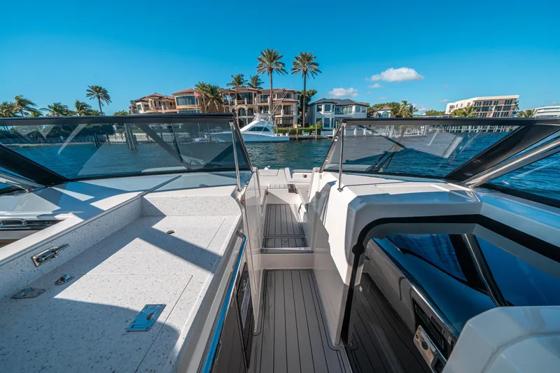 Slide: The Image of Aquila 32 Sport 2022 boat interior with waterfront view, modern design, and clear blue sky. - 32