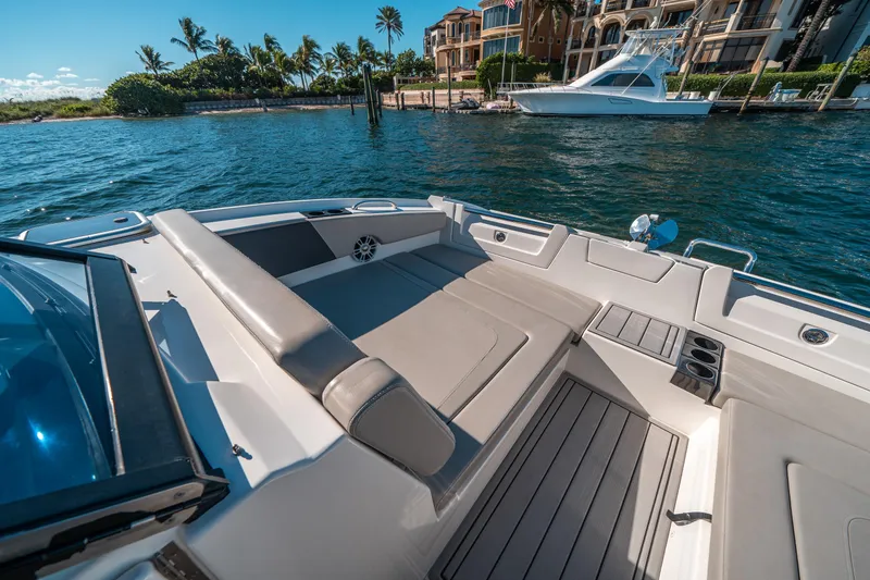 Slide: The Image of Aquila 32 Sport 2022 boat interior with luxurious seating and scenic waterfront view. - 33