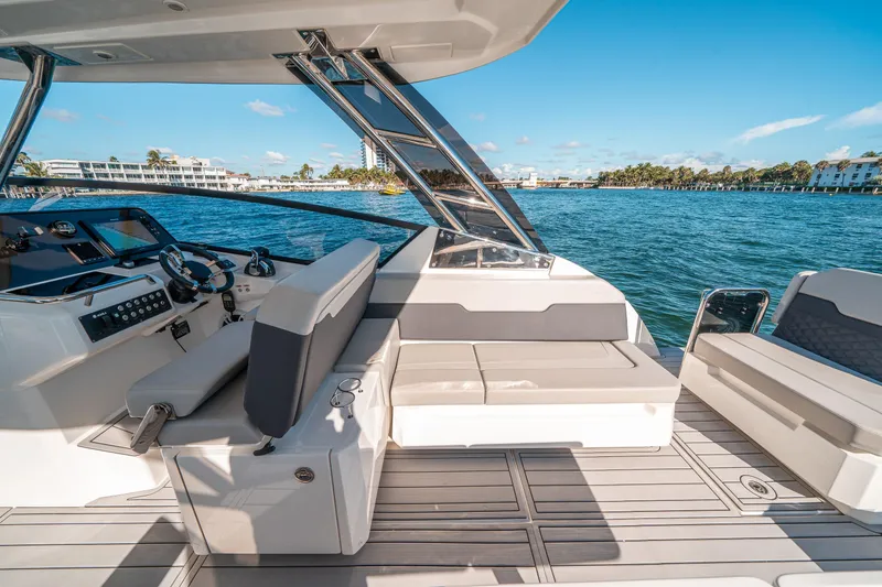 Slide: The Image of 2022 Aquila 32 Sport yacht interior with seating, steering, and ocean view. - 40