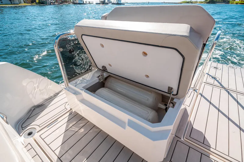 Slide: The Image of Aquila 32 Sport 2022 boat with open storage compartment on deck. - 41