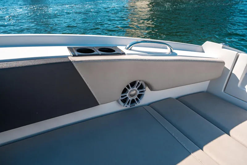 Slide: The Image of 2022 Aquila 32 Sport boat interior with cushioned seating and cup holders. - 46