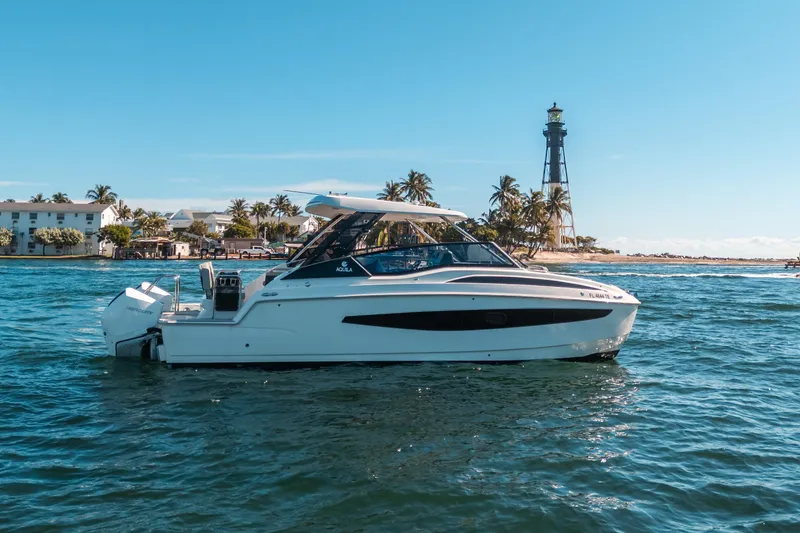 Slide: The Image of Aquila 32 Sport 2022 boat on water near lighthouse and palm trees. - 52