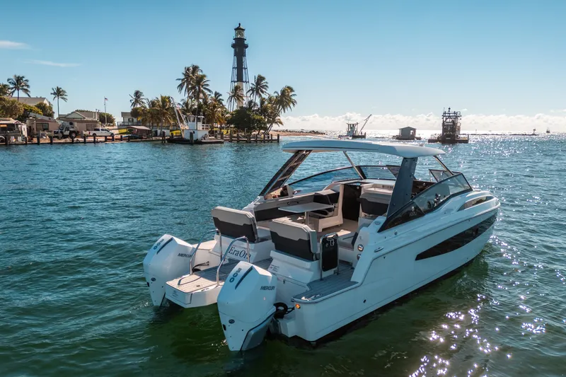 Slide: The Image of Aquila 32 Sport 2022 boat on water near a lighthouse and palm trees. - 55