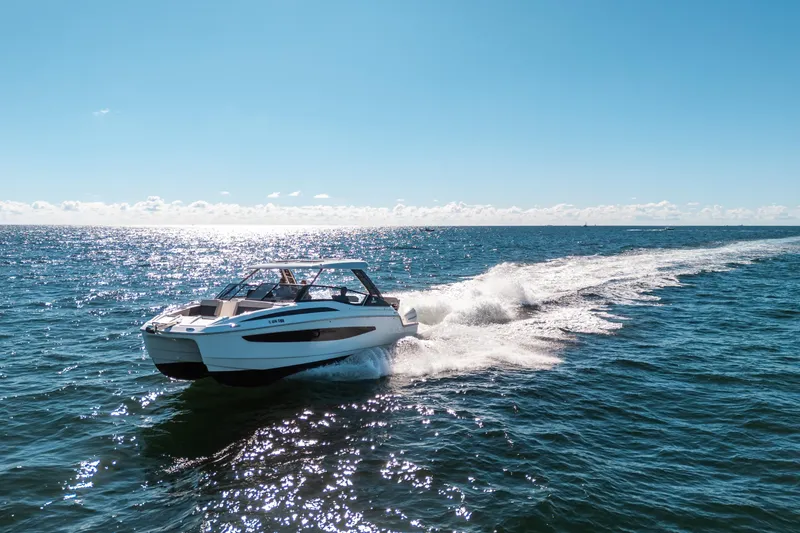 Slide: The Image of Aquila 32 Sport 2022 cruising on open sea under clear blue sky. - 59