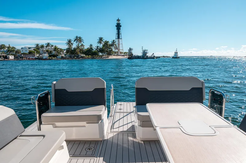 Slide: The Image of Aquila 32 Sport 2022 boat with ocean view and distant lighthouse. - 6