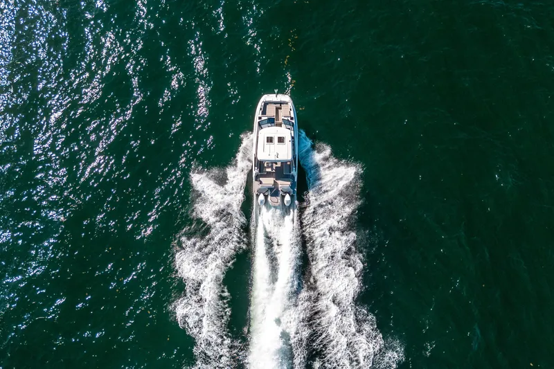 Slide: The Image of Aquila 32 Sport 2022 cruising on open water, aerial view. - 62