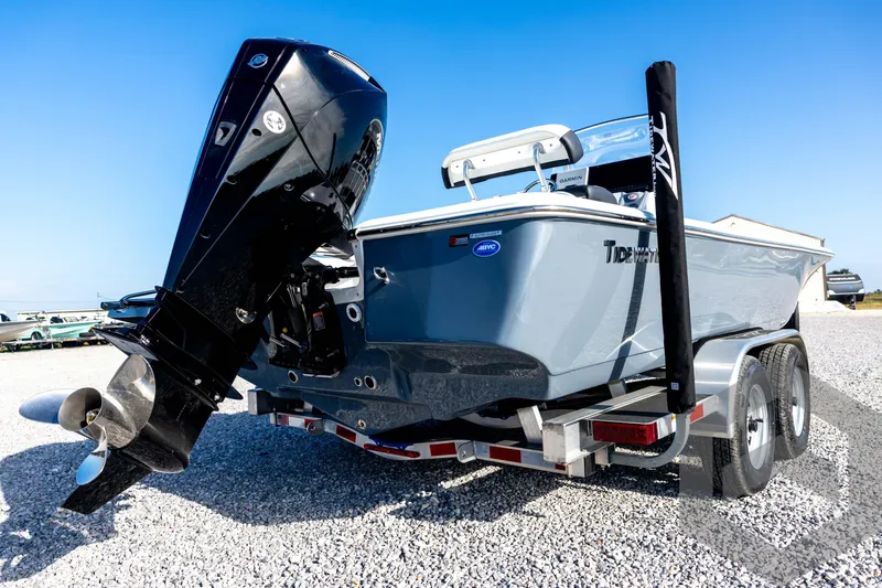 Slide: The Image of 2026 Tidewater 2110 Bay Max boat on trailer, featuring powerful outboard motor. - 14