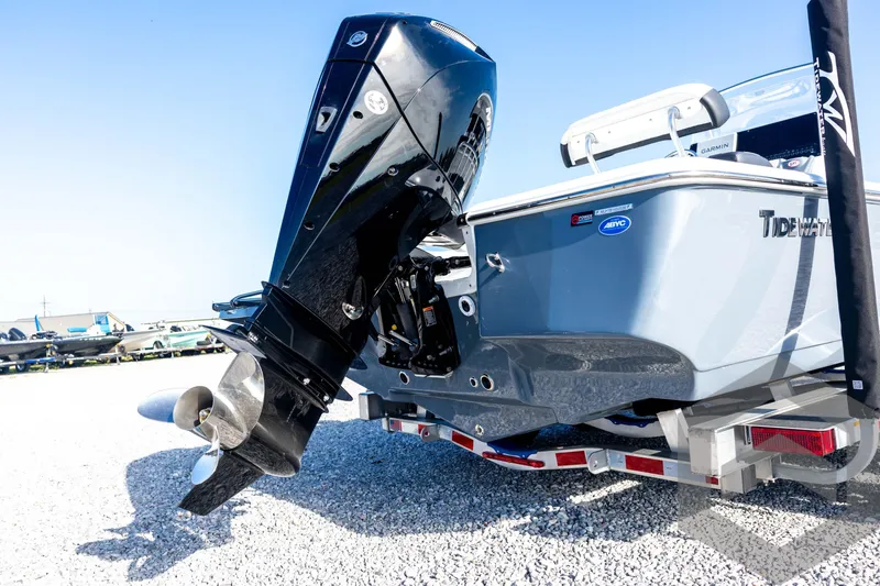 Slide: The Image of 2026 Tidewater 2110 Bay Max boat with outboard motor on a trailer. - 16