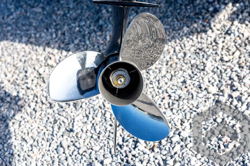 Slide: The Image of Close-up of a shiny boat propeller on gravel, Tidewater 2110 Bay Max 2026. - 18
