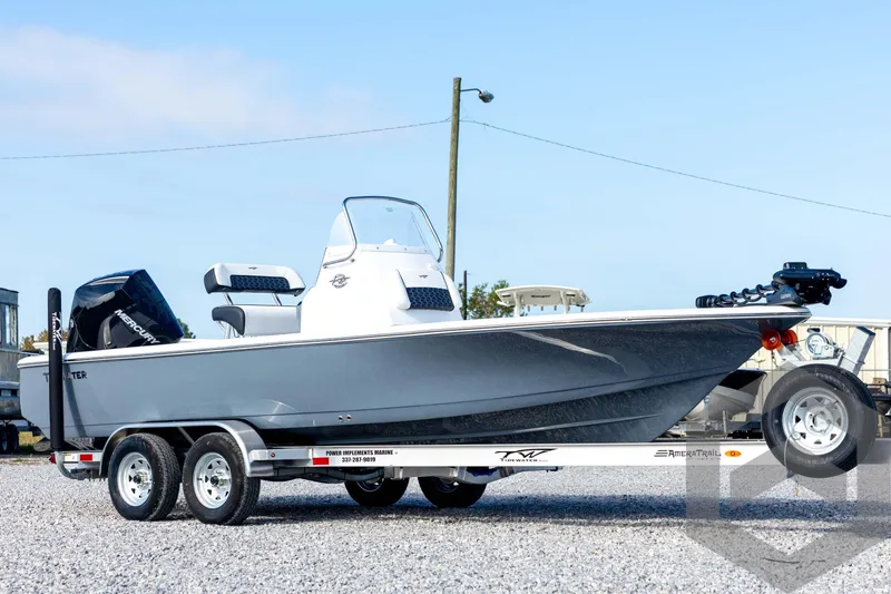 Slide: The Image of 2026 Tidewater 2110 Bay Max boat on trailer, featuring sleek design and modern outboard motor. - 3