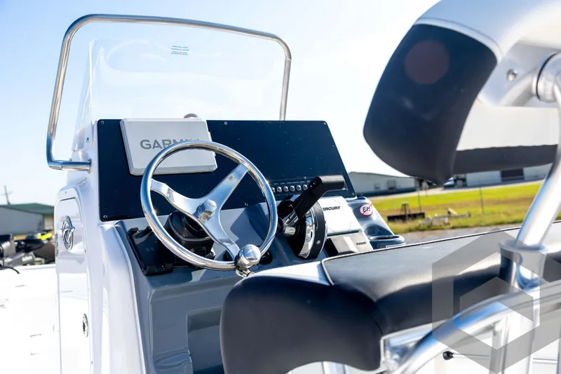 Slide: The Image of 2026 Tidewater 2110 Bay Max boat console with steering wheel and Garmin display. - 34
