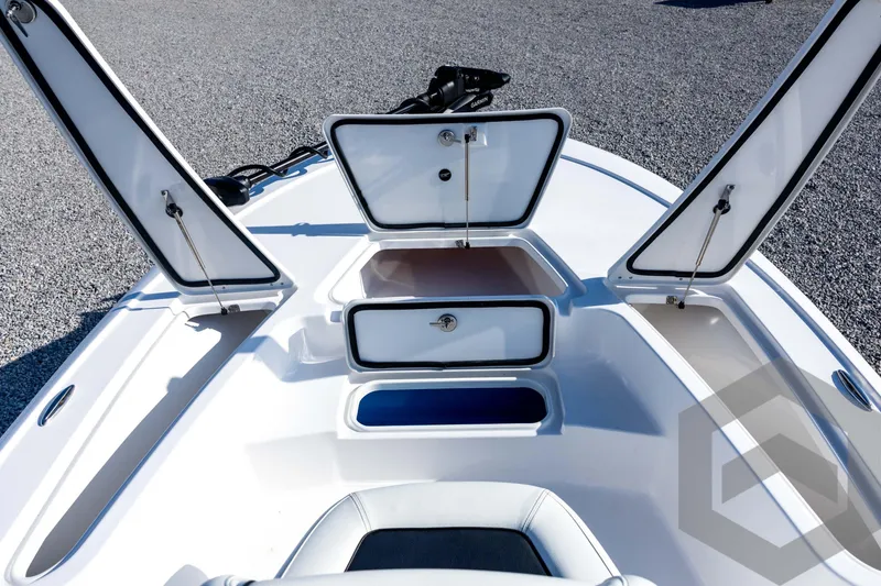 Slide: The Image of 2026 Tidewater 2110 Bay Max boat with open storage compartments on deck. - 39