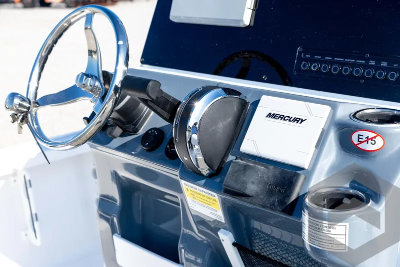 Slide: The Image of 2026 Tidewater 2110 Bay Max boat console with Mercury controls and steering wheel. - 54