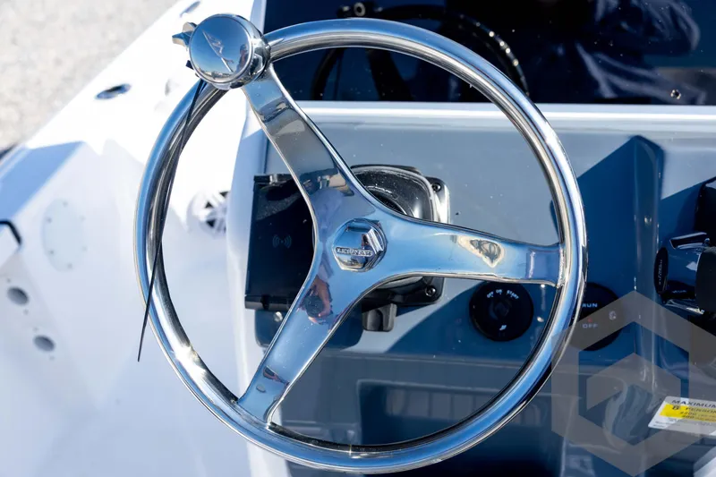 Slide: The Image of Steering wheel of 2026 Tidewater 2110 Bay Max boat, featuring sleek chrome design. - 57