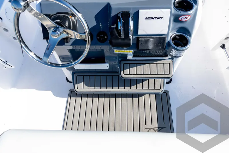 Slide: The Image of 2026 Tidewater 2110 Bay Max boat console with steering wheel and Mercury controls. - 60
