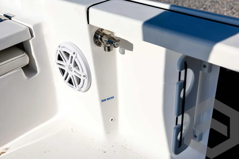 Slide: The Image of 2026 Tidewater 2110 Bay Max boat interior with speaker and raw water outlet. - 62