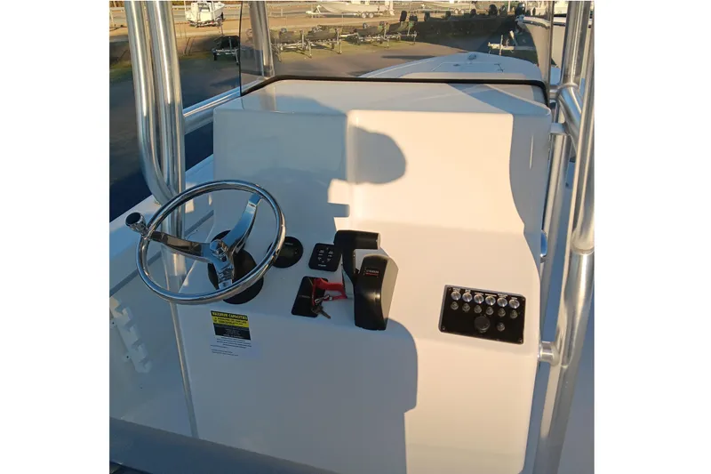 Slide: The Image of 2026 May-Craft 238 CC boat console with steering wheel and control panel. - 11
