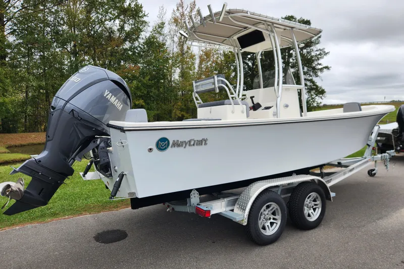 Slide: The Image of 2026 May-Craft 238 CC boat on trailer with Yamaha engine, parked outdoors. - 2