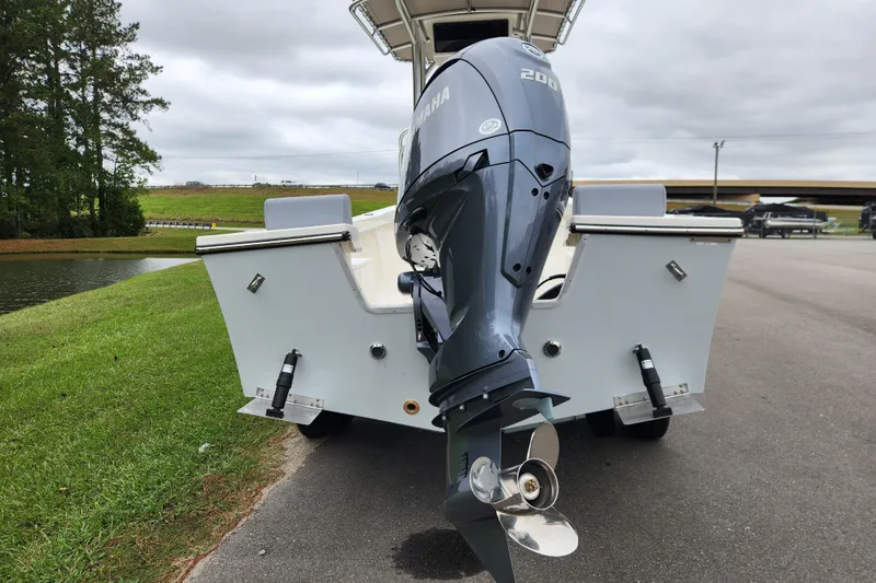 Slide: The Image of 2026 May-Craft 238 CC boat with Yamaha 200 engine, parked near a pond. - 3