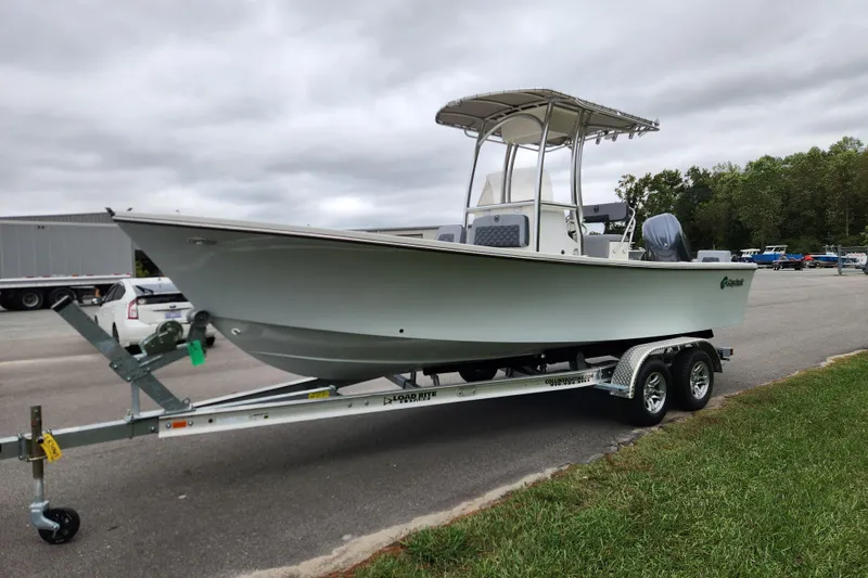 Slide: The Image of 2026 May-Craft 238 CC boat on trailer, parked outdoors under cloudy sky. - 6